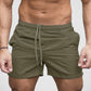 Light green drawstring beach shorts on model showing side seam pocket