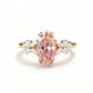 Studio macro on white, 6mm by 12mm marquise simulated padparadscha stone and clear side clusters