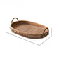 Small oval rattan tray with studded wooden rim and two arched handles on white, Small size option