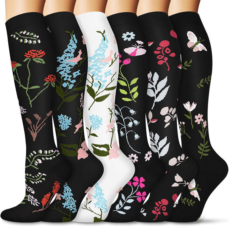 Six knee-high compression socks in botanical floral and butterfly print designs