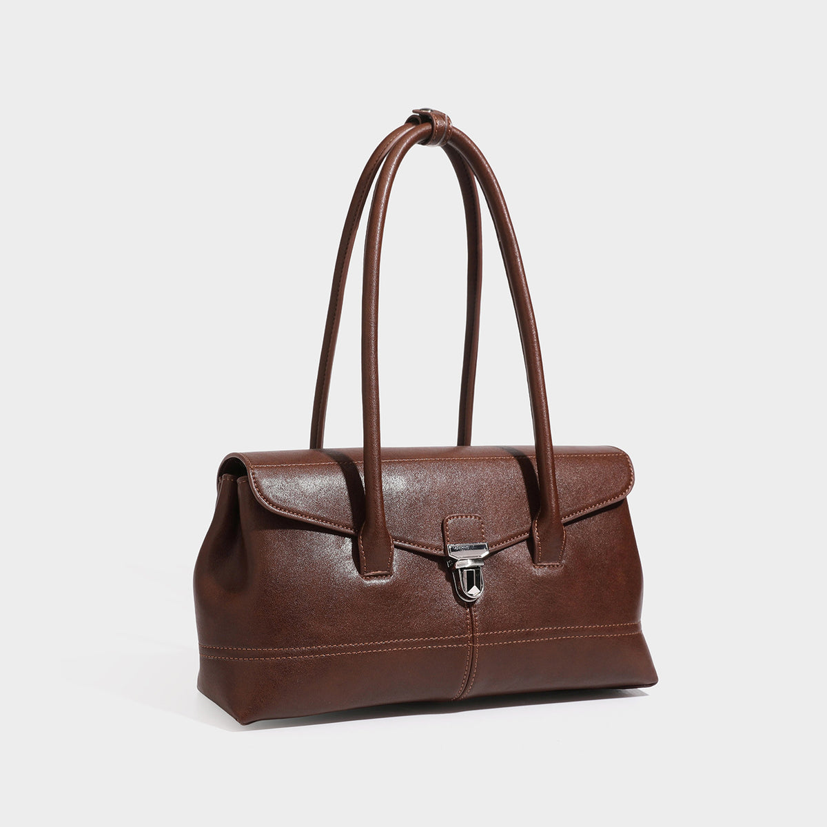 Coffee brown PU leather baguette shoulder bag with push lock flap and two long rolled handles, three quarter view