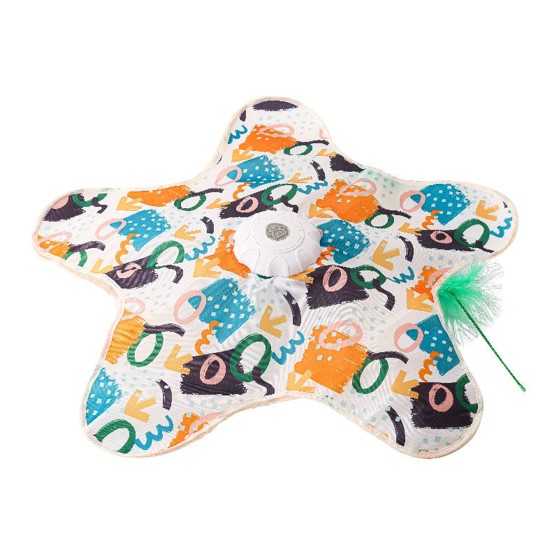 Flat lay of the graffiti print star cat teaser mat with white motor puck and green feather wand