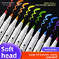 Row of soft brush acrylic markers on black with opaque colored swirls above each nib