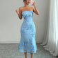 Mirror shot of the strapless mesh dress showing the ribbon daisies across the bodice and skirt