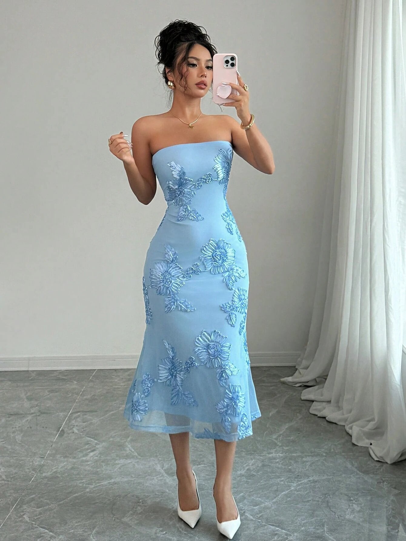 Mirror shot of the strapless mesh dress showing the ribbon daisies across the bodice and skirt
