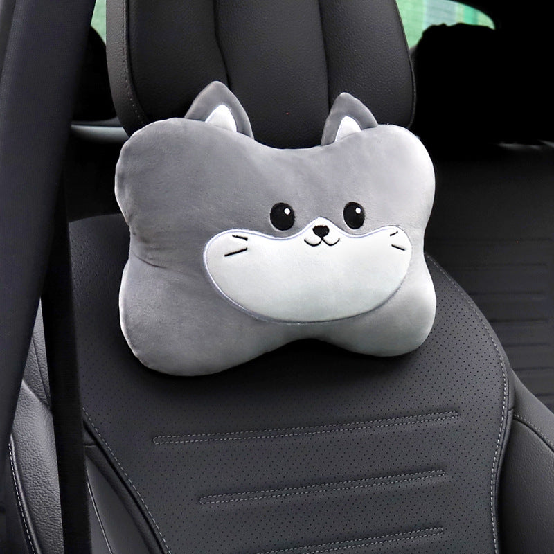 Gray cat headrest pillow with a white muzzle shown alone on a black car seat