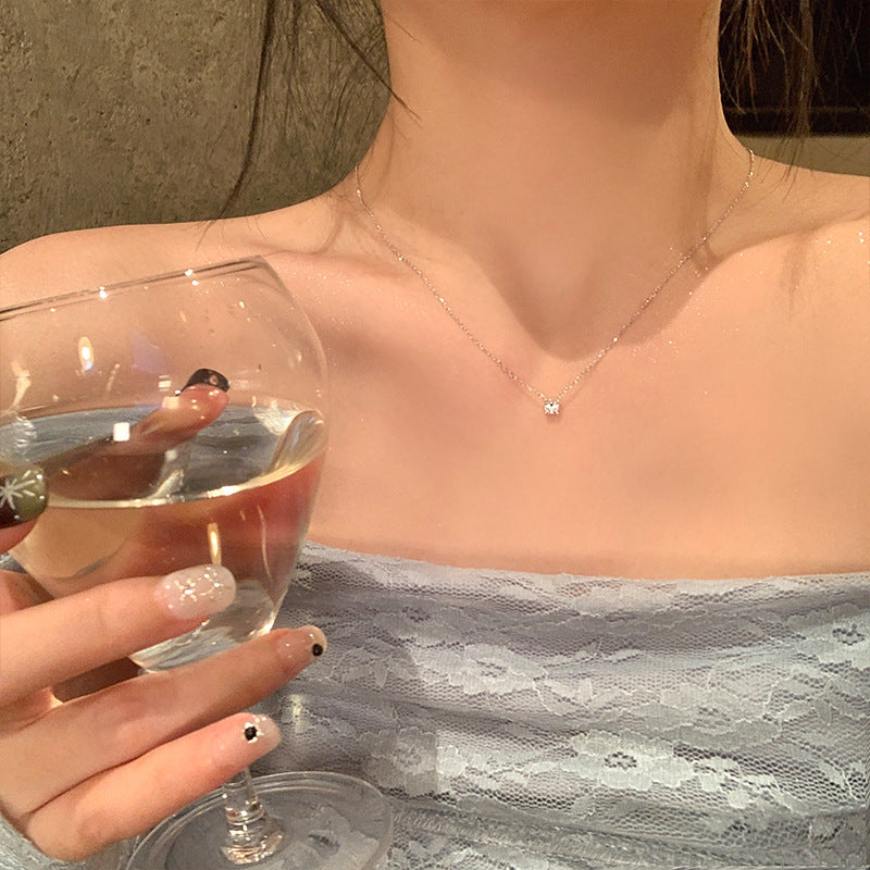Pendant necklace worn at the base of the neck, single faceted stone centred