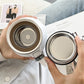 Looking down into a white flask with the perforated tea strainer seated in the neck
