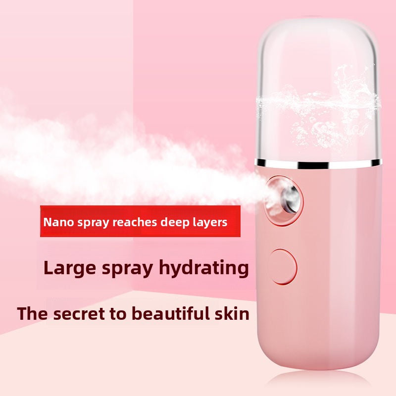 Pink nano facial mister releasing a fine cold mist toward a woman's cheek