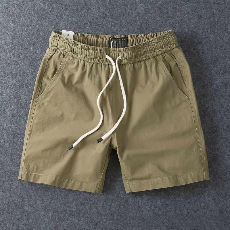 Khaki men's cotton drawstring shorts framed close on the waist and flat cotton drawstring