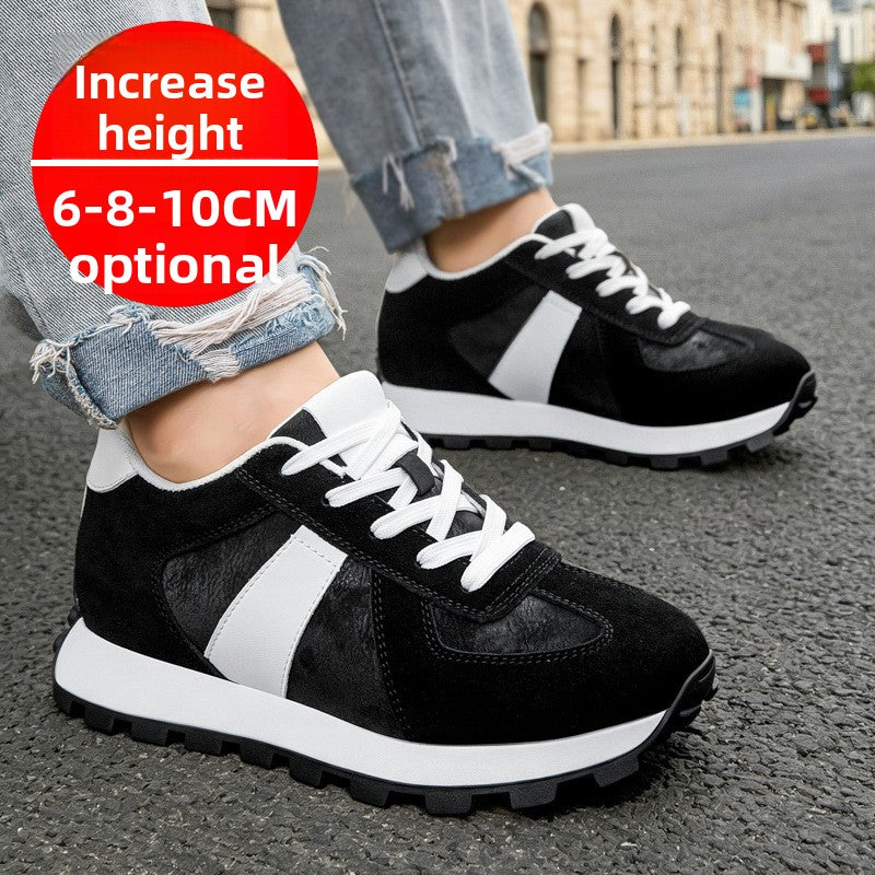 Man wearing black suede low top lace up sneakers with a white side stripe on asphalt