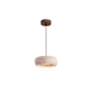 Natural travertine pendant shade casting up and down light against a calm neutral wall