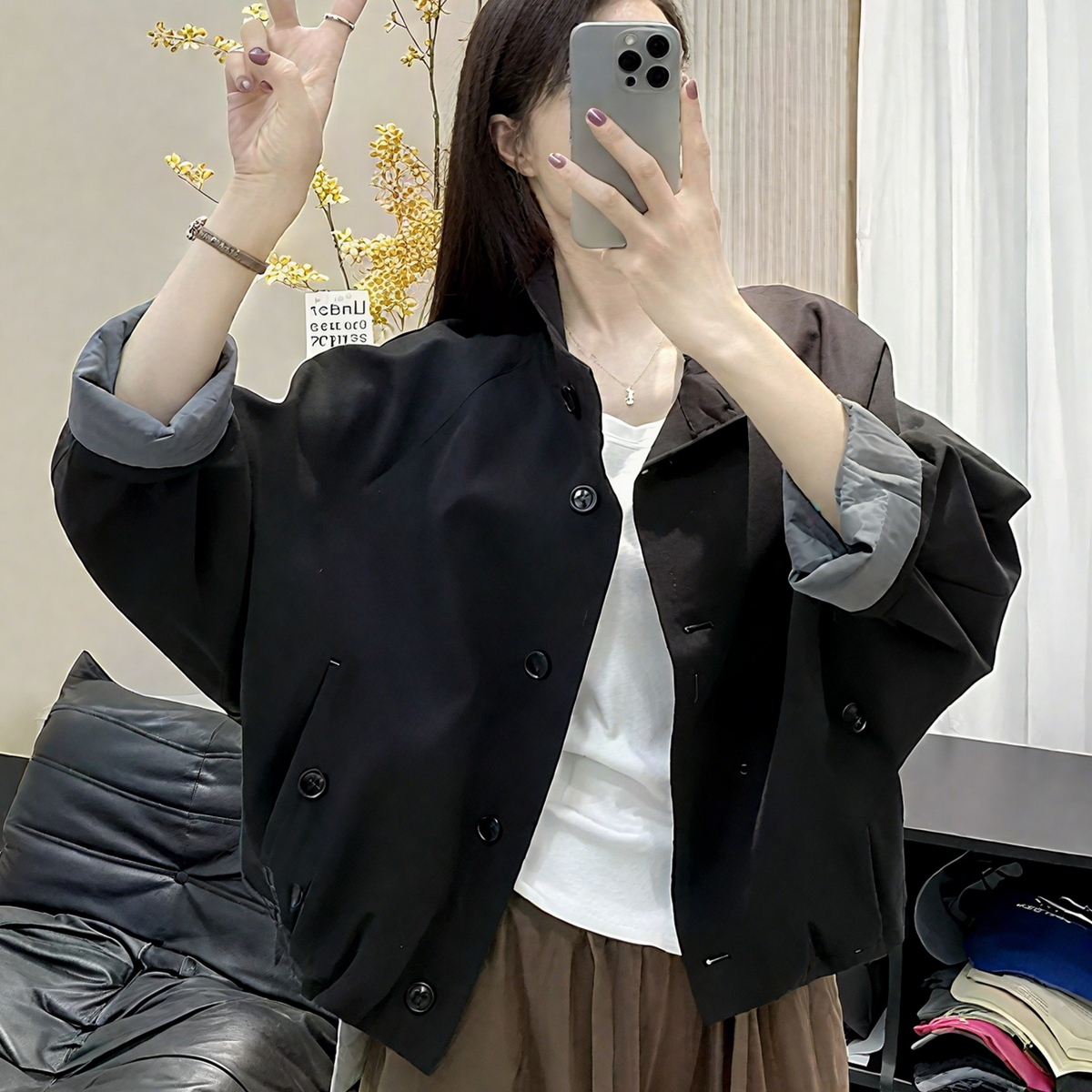 Womens casual button front short jacket in black, worn over a tee