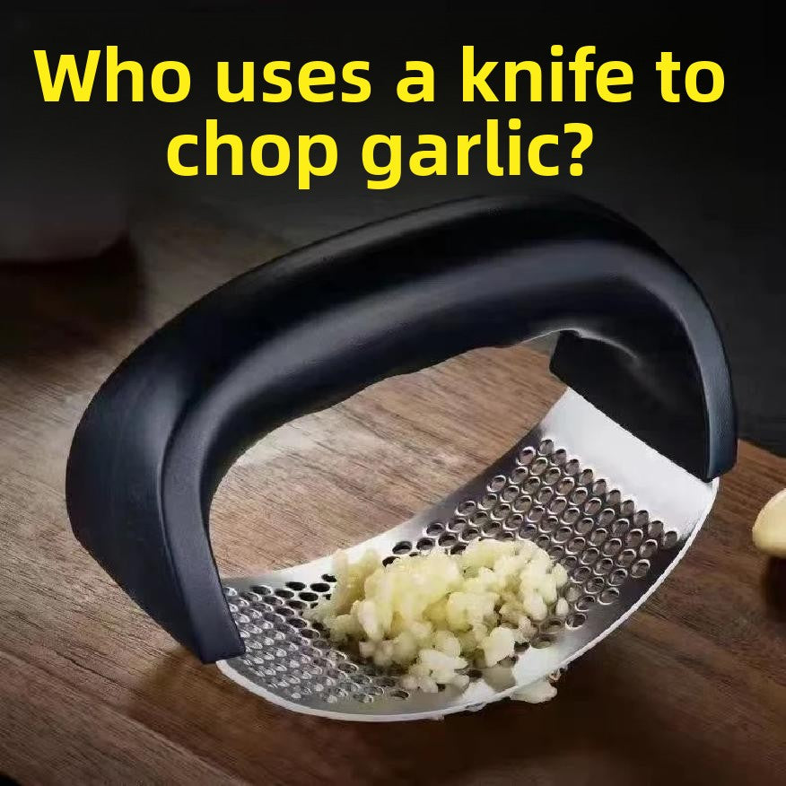 Rocking garlic press mincing peeled cloves into paste through the perforated plate on wood