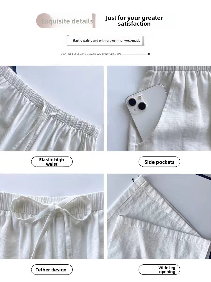 Womens high waist wide leg linen blend drawstring trousers, side view showing the wide leg drape to the ankle