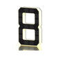 Black and gold solar LED house number sign, one character with a backlit warm outline, three quarter view