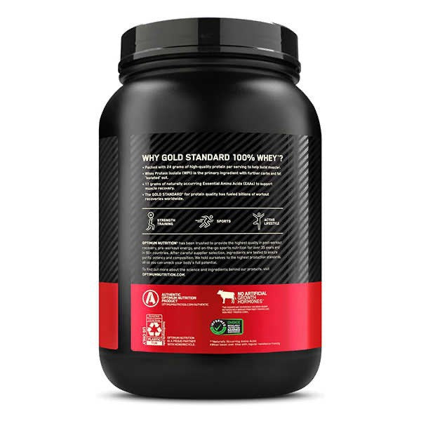 Whey protein shake mixed in a shaker bottle beside the tub