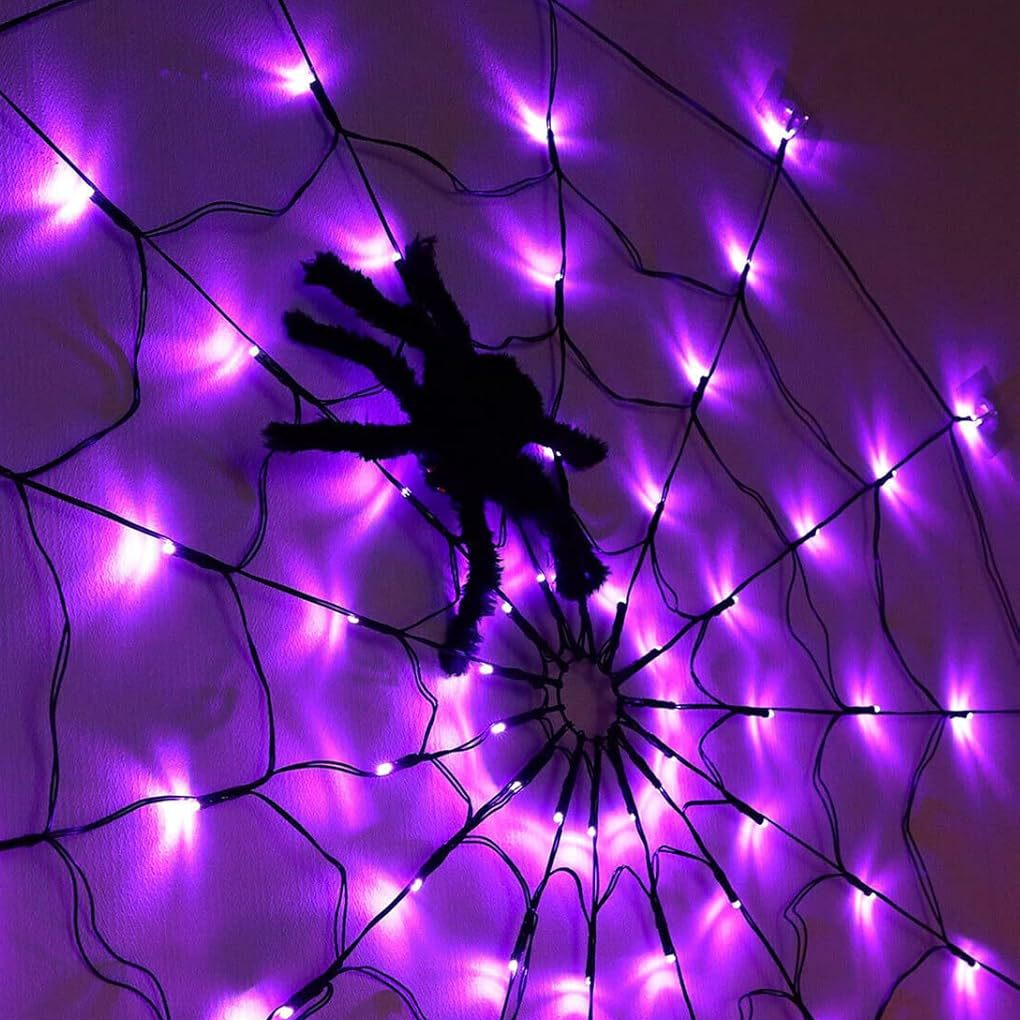 Close view of a purple lit spider web net light with a black spider prop