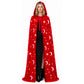 Woman in a red hooded velvet cloak with silver stars and crescent moons and ribbon ties at the neck