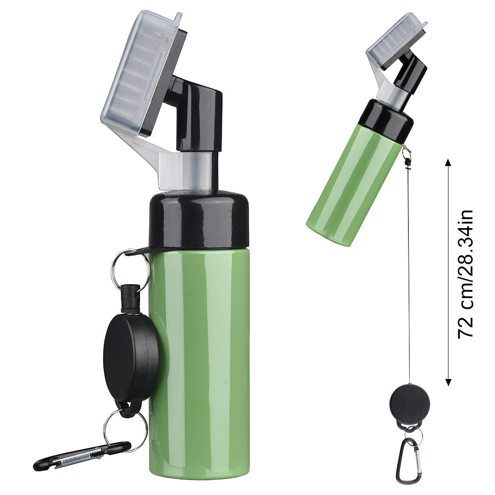 Golf club cleaning spray brush in white, black and green with a black brush head