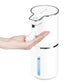 White sensor soap dispenser dispensing a dome of foam onto an open hand, level window in view