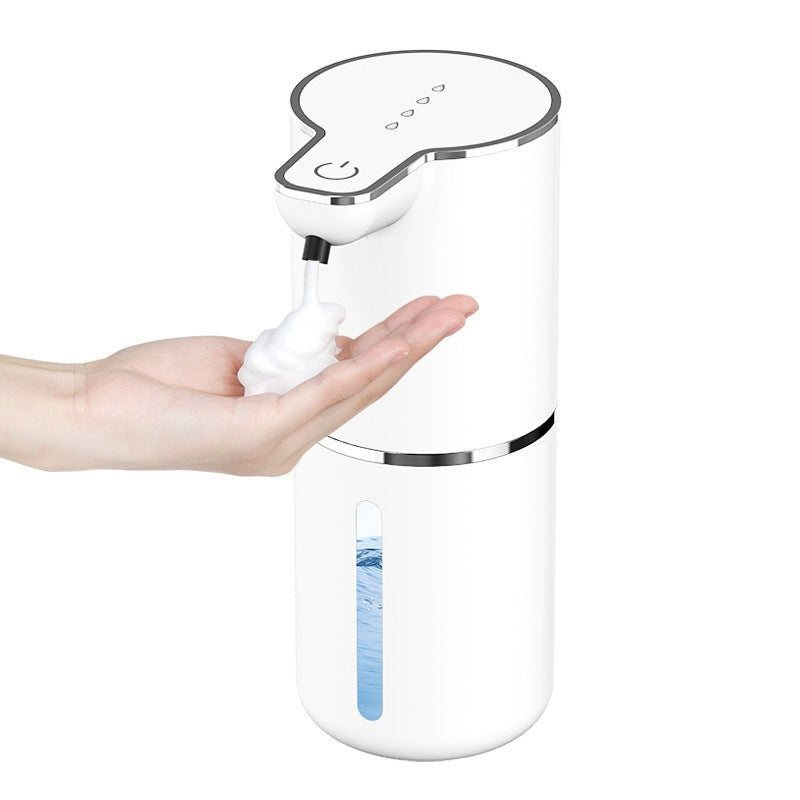 White sensor soap dispenser dispensing a dome of foam onto an open hand, level window in view