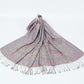 Mauve gray paisley shawl with a pastel border and gray tassels spread on a white background
