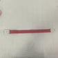 Single rose pink elastic quick release tourniquet band with a white snap buckle laid flat
