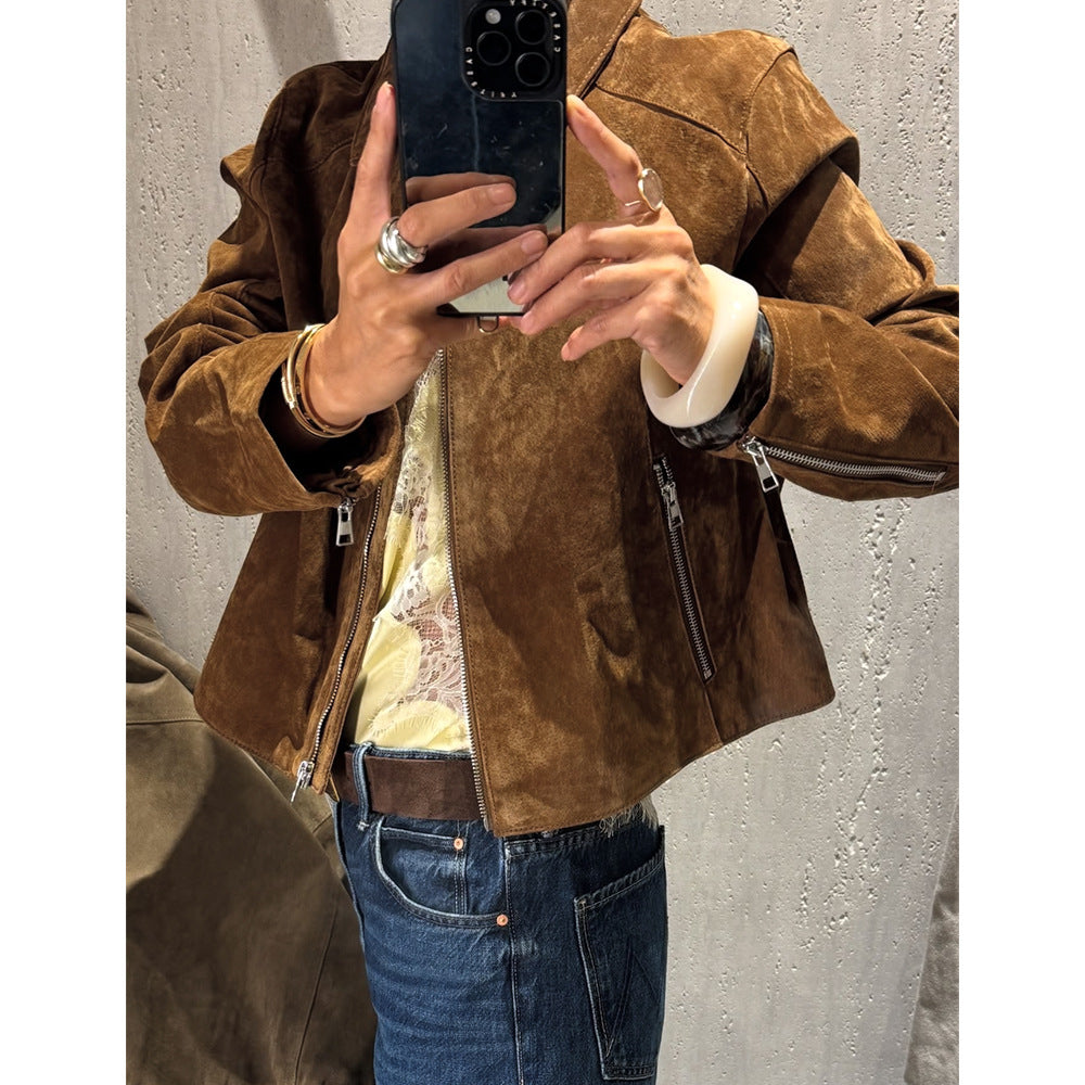 Model wears the dark brown vegan suede jacket with the front zip partway down