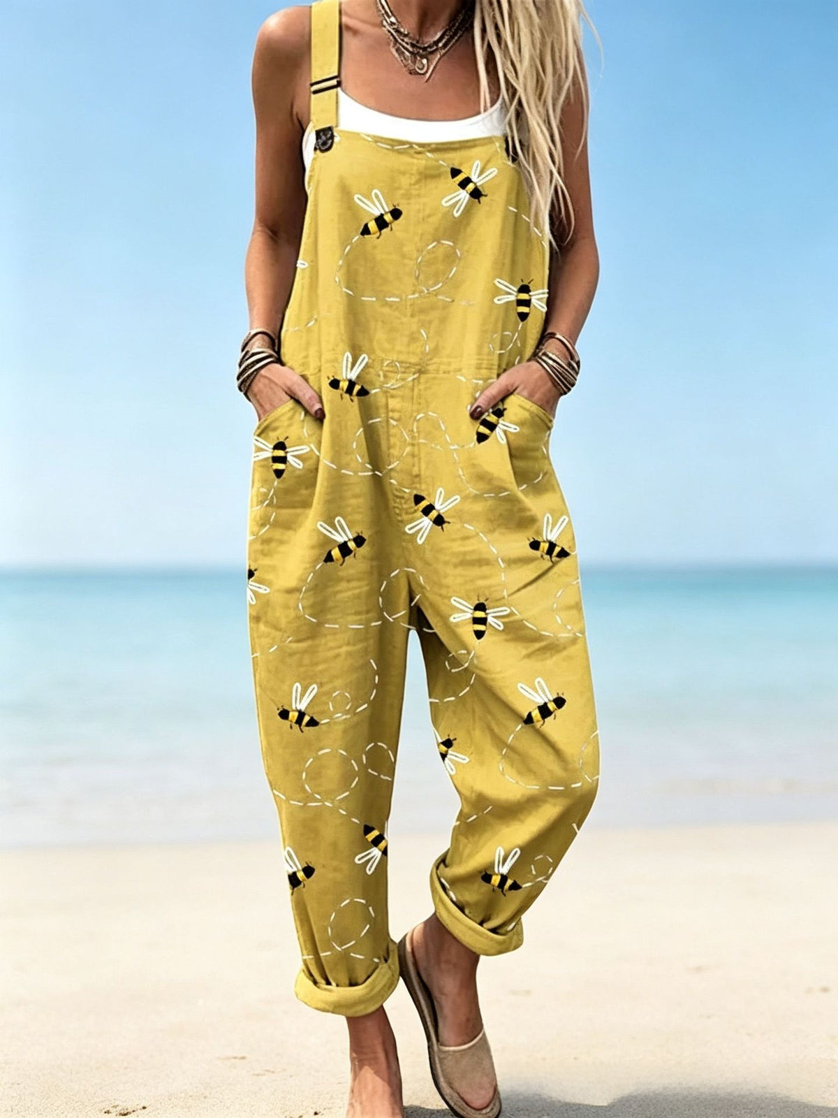 Size 2XL option: Mustard yellow overalls with a bee and dotted flight path print, cuffed legs and pockets