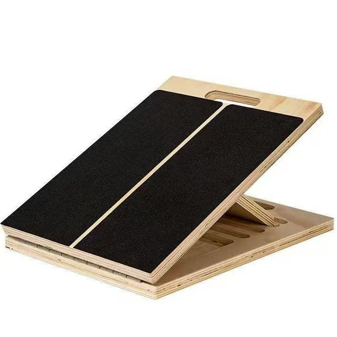 Wooden stretching board tilted up with a black non-slip panel in two halves and a hand cutout at the back edge