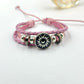 Close view of a braided cord bracelet showing the three strand weave and beads