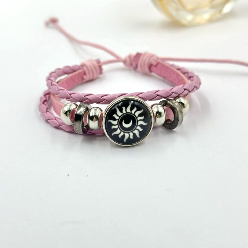 Close view of a braided cord bracelet showing the three strand weave and beads
