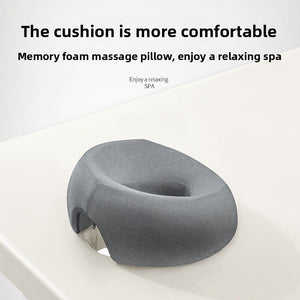 Gray memory foam face rest pillow with the open center facing up, ready to lower your face into