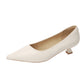 Cream pointed toe slip-on pump with a low flared heel on a white background, side view