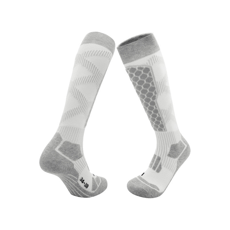 Thick knit ski socks with an arrow pattern up the shin and a padded footbed on white