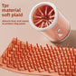 Maker panel showing the soft TPR bristle mat unrolled flat beside the orange pet paw wash cup
