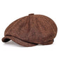 Close view of the slubby linen look weave and covered top button on the newsboy cap
