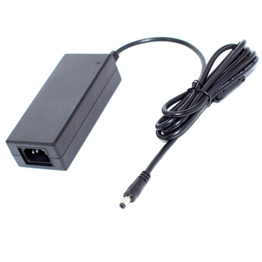 Rear view of a black 72W desktop power supply showing the AC input socket and DC barrel plug on the output cord