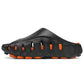 Black EVA outdoor clog in profile with oval side vents and orange midsole showing through