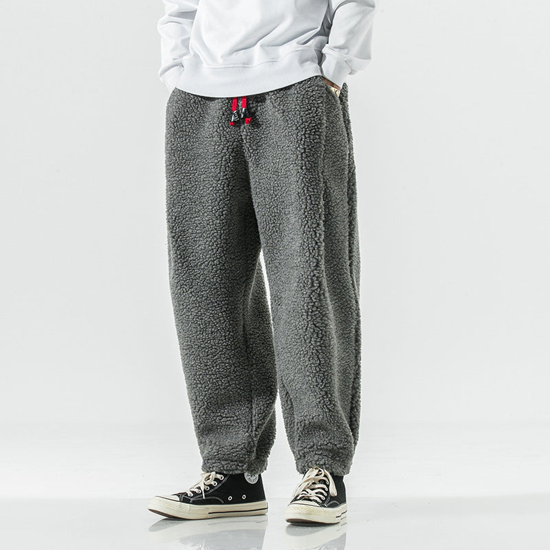 Grey plush harem pants with red drawcord, front view with white sweatshirt and high top sneakers