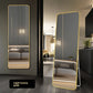 Gold toned framed wall mirror hung on a neutral wall in a dressing corner