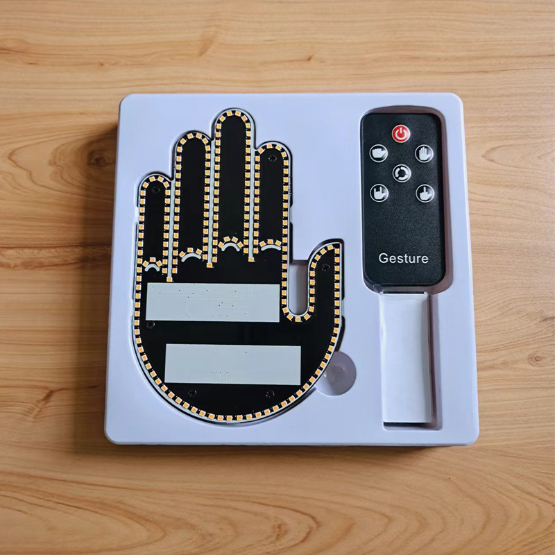 Womens gesture light option: hand-shaped LED panel and remote in a white tray, thumb alongside the palm