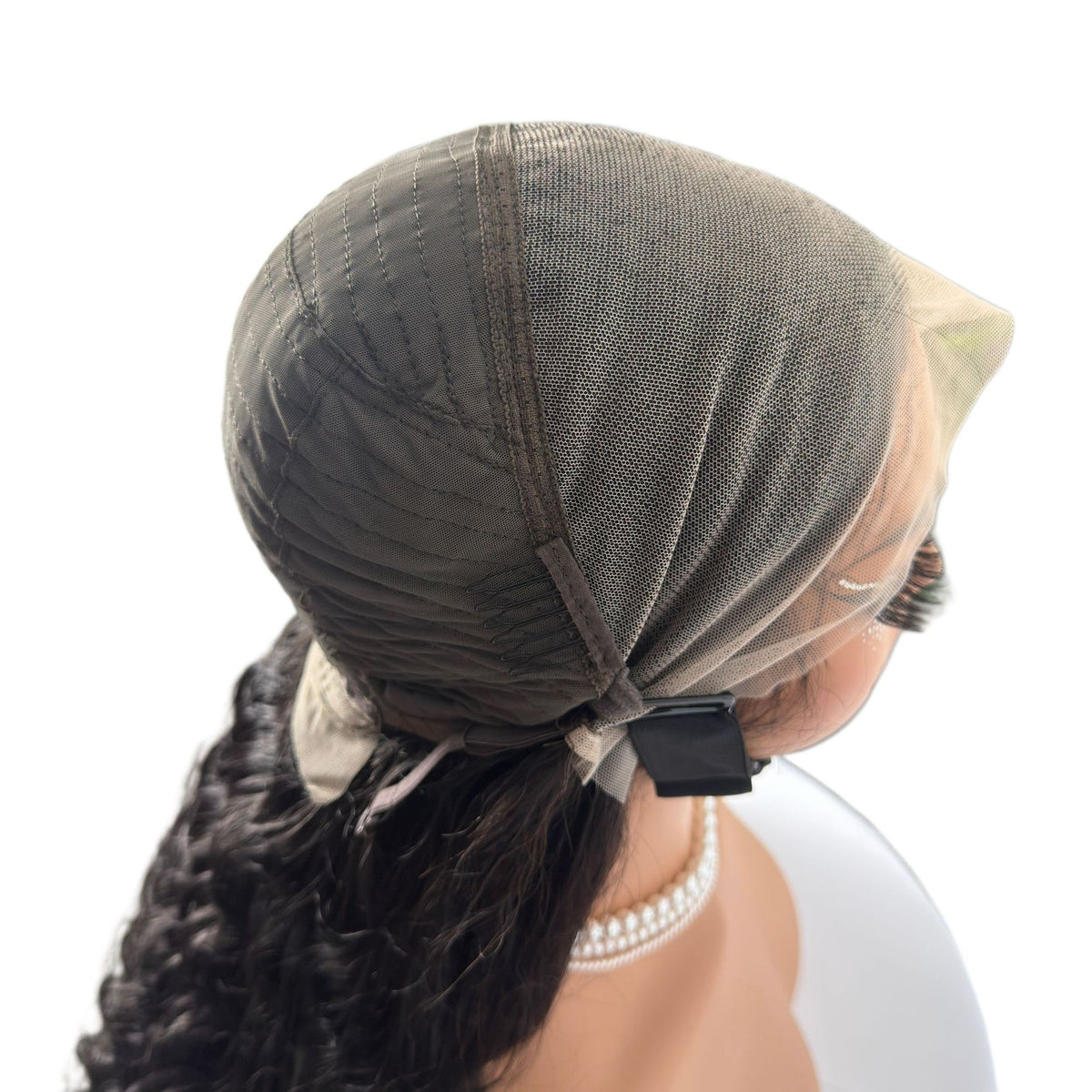 Inside of the wig cap with a mesh lining and an adjustable strap clip at the nape