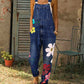 Dark blue denim print bib overalls with large flowers down one leg, option photo for size 3XL