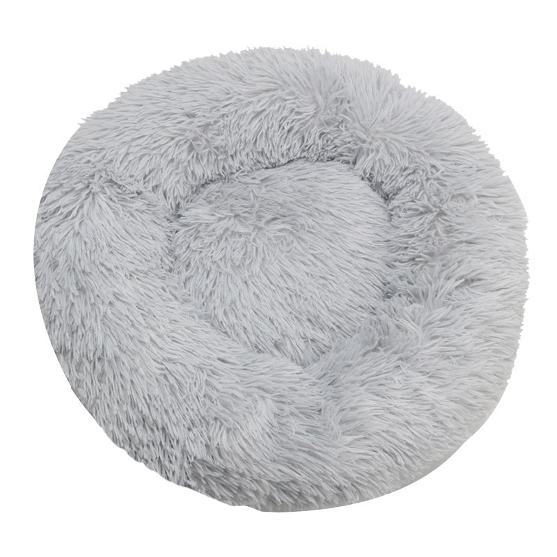 Light gray round plush pet bed with a raised bolster rim on a plain background