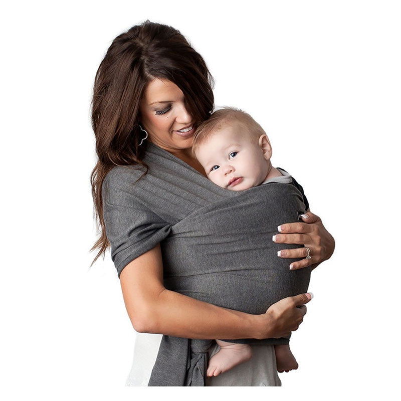 Baby wrap sling carrier in soft studio light showing the knit fabric drape