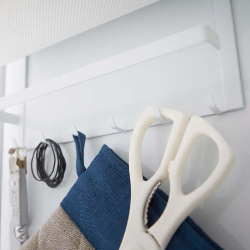 Paper towel roll held on the sprung bar of the magnetic fridge storage rack