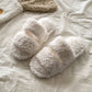 Curly plush upper detail of the open toe house slipper in a soft solid color