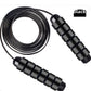 Plain black skipping rope laid flat on white with the coated steel cable coiled